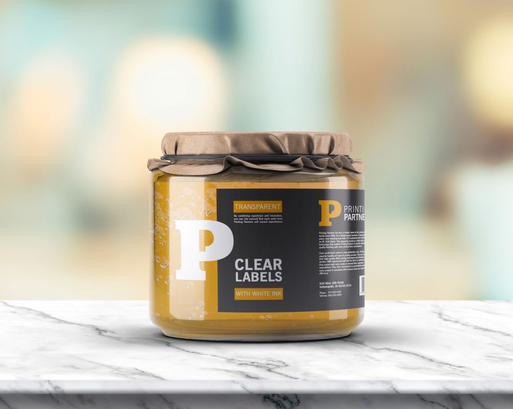 Glass jar featuring clear labels with white ink printing from Printing Partners.