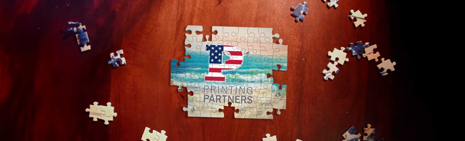 A partially completed puzzle featuring the Printing Partners logo and an American flag design.
