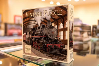 Box of a vintage train puzzle featuring a steam locomotive design.
