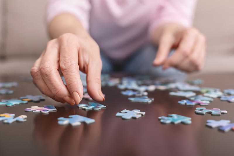 Woman Putting Puzzle Together