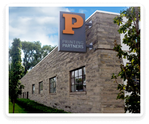 Exterior view of Printing Partners building with a prominent sign featuring the letter P.