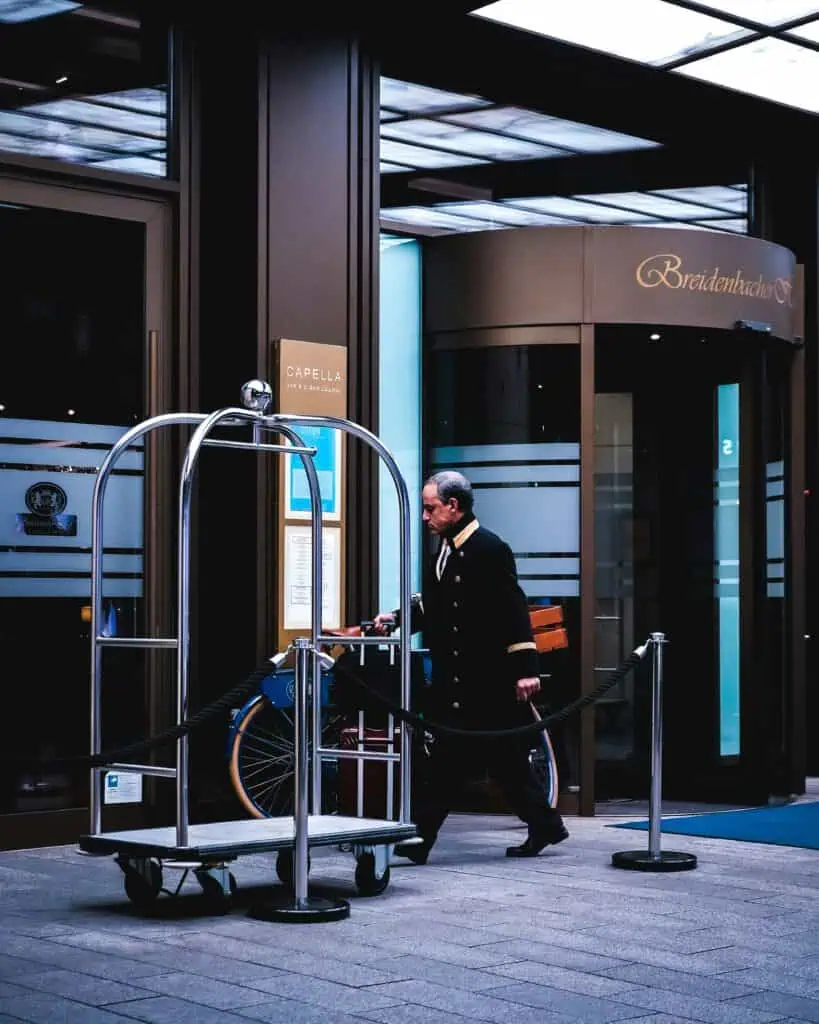 Luxury concierge assisting a client with a private jet itinerary and champagne service.