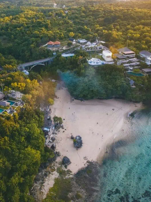 a beach with houses and trees