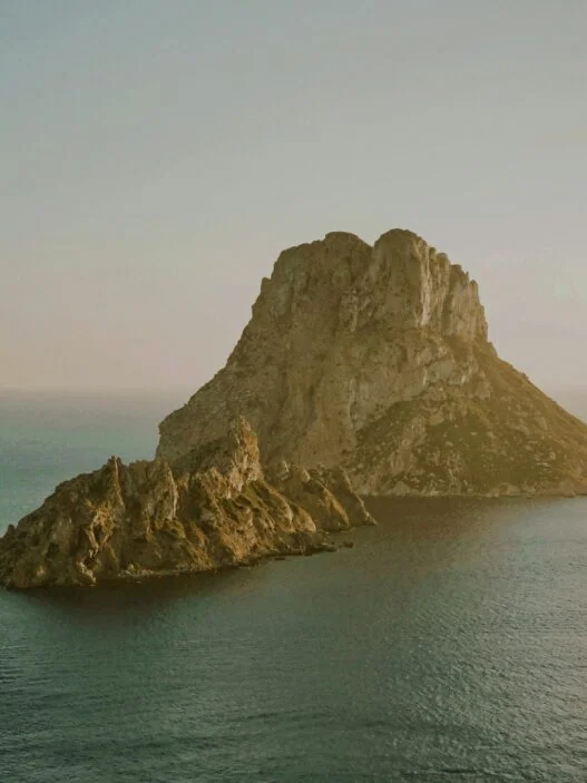 Ibiza wellness retreat sunrise yoga session on Mediterranean cliffside terrace with ocean views