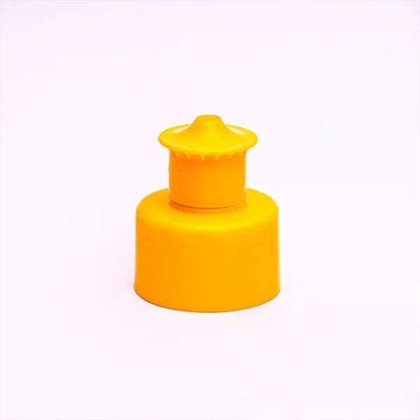 Yellow plastic bottle cap, close-up isolated on white background, used for sealing beverages or bottles, durable and lightweight packaging accessory.