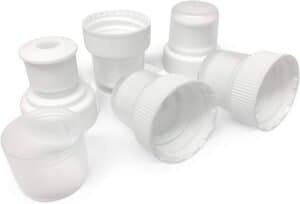 White plastic bottle caps and closures for packaging and storage solutions. Suitable for pharmaceuticals, cosmetics, and food industries, ensuring secure sealing and product freshness.