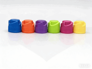 Brightly colored plastic bottle caps including blue, orange, purple, green, pink, and yellow, arranged in a line on a white surface, showcasing variety and vibrant colors.