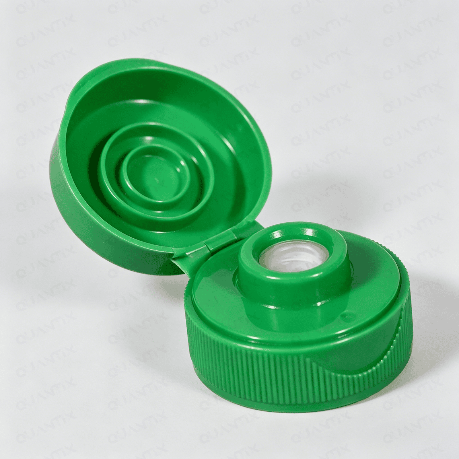 Green flip top cap with secure closure for bottles and containers.
