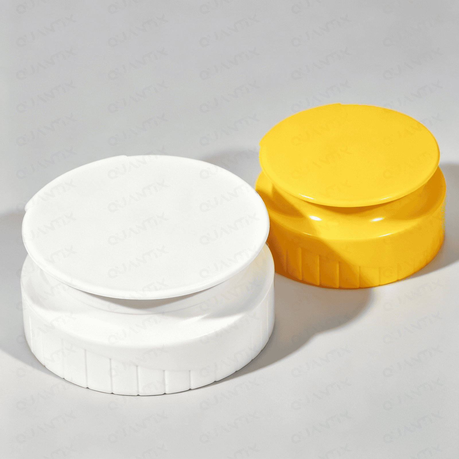 Close-up of white and yellow flip top caps for bottles, showcasing their design and functionality for secure sealing and easy opening.