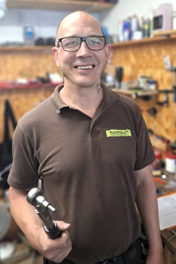 Mitarbeiter von Radfalk Radsport mit Werkzeug in Werkstatt.