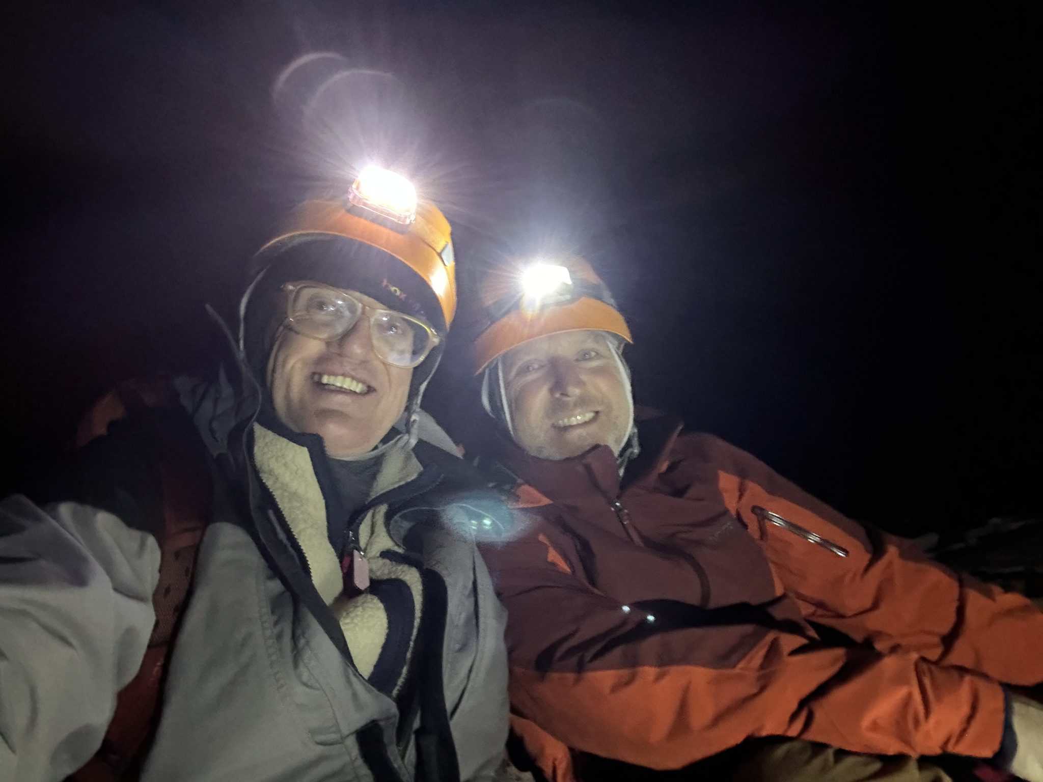 Two men with headlamps on Mt Cotopaxi