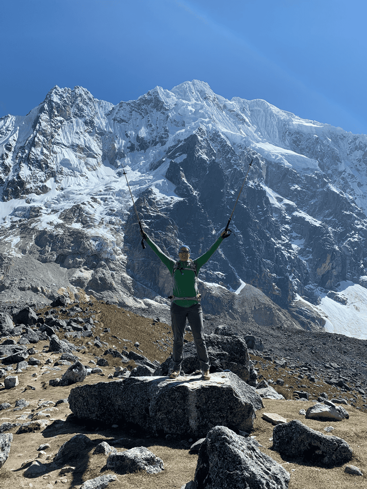 Woman with her hands up on Salkantay Pass