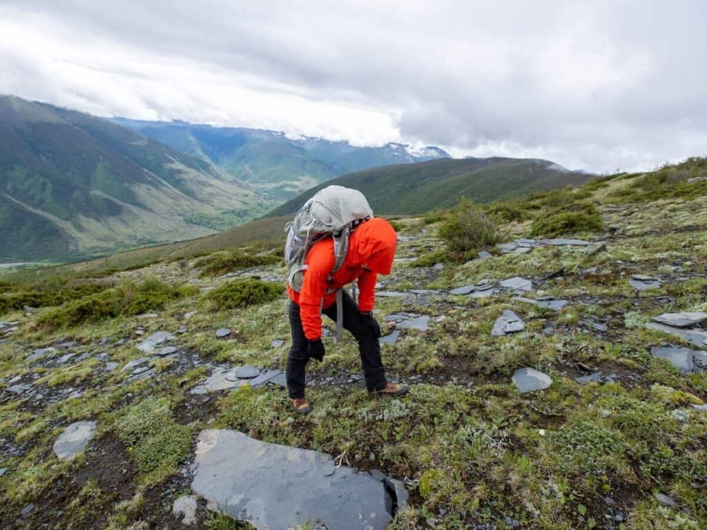 Mountain athlete struggling to breath while trekking