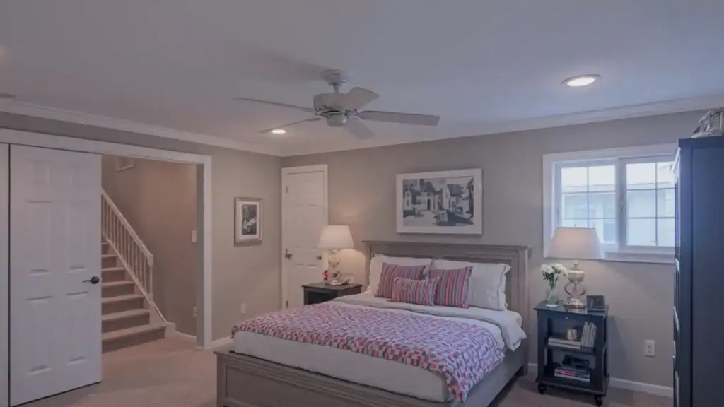 Finished basement bedroom with egress window, proper ceiling height, and ventilation design
