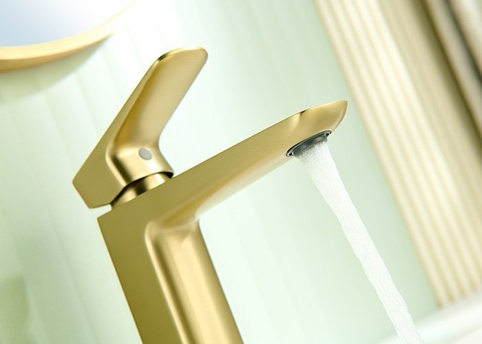 Close shot of waterflow of the PVD brushed gold bathroom faucet with single handle sleek modern design - B00201431