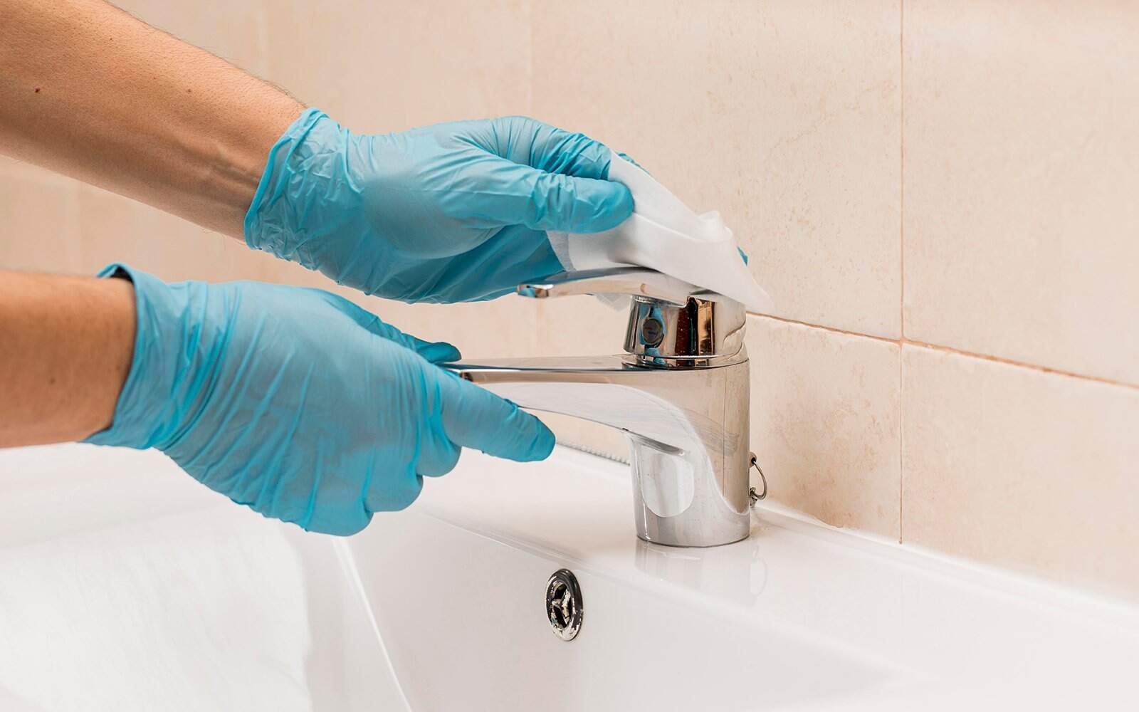 Dip your cloth in wring it out and wipe the whole faucet