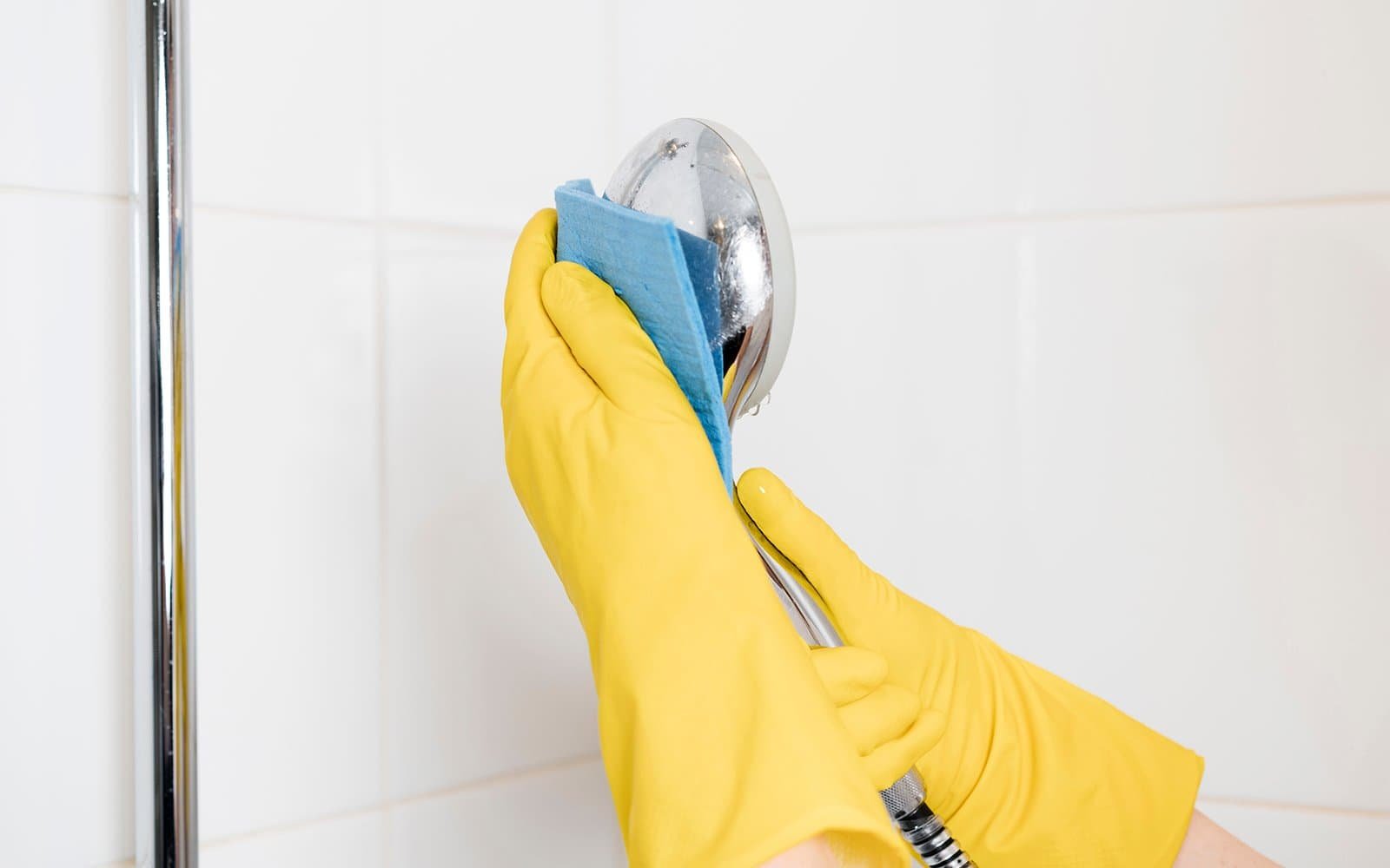 Shower head getting cleaned - Regular Maintenance