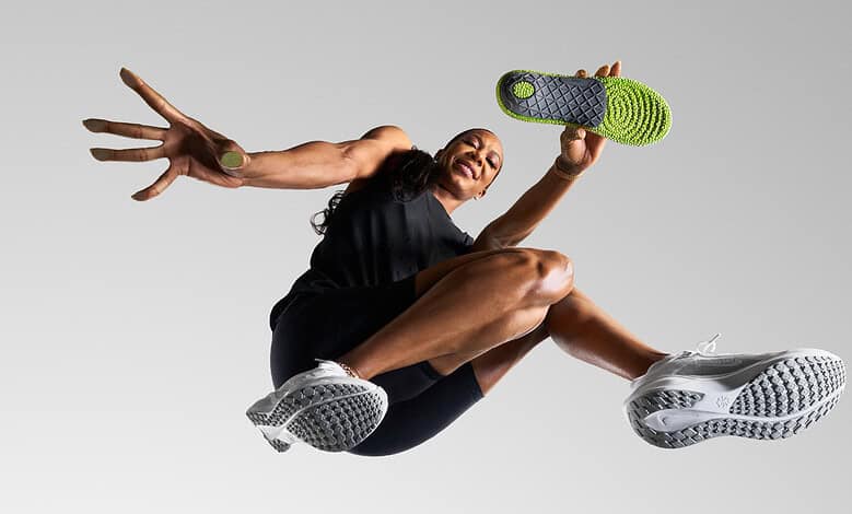 Athlete mid-air in a dynamic running pose, showcasing athleticism and energy, wearing modern running shoes.