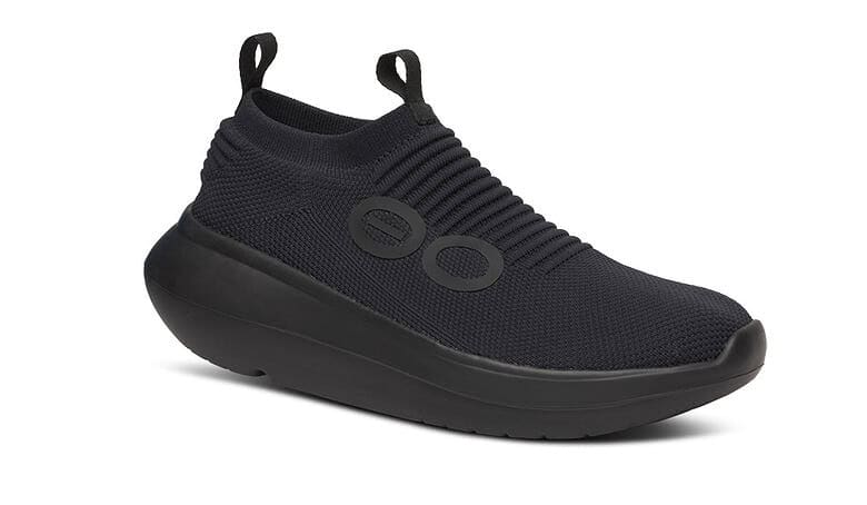 Black athletic running shoe with slip-on design and cushioned sole, ideal for running and sports activities.