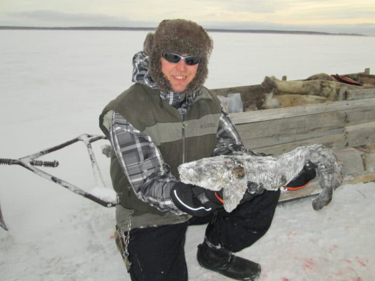 Ice fishing on frozen Lake Inari