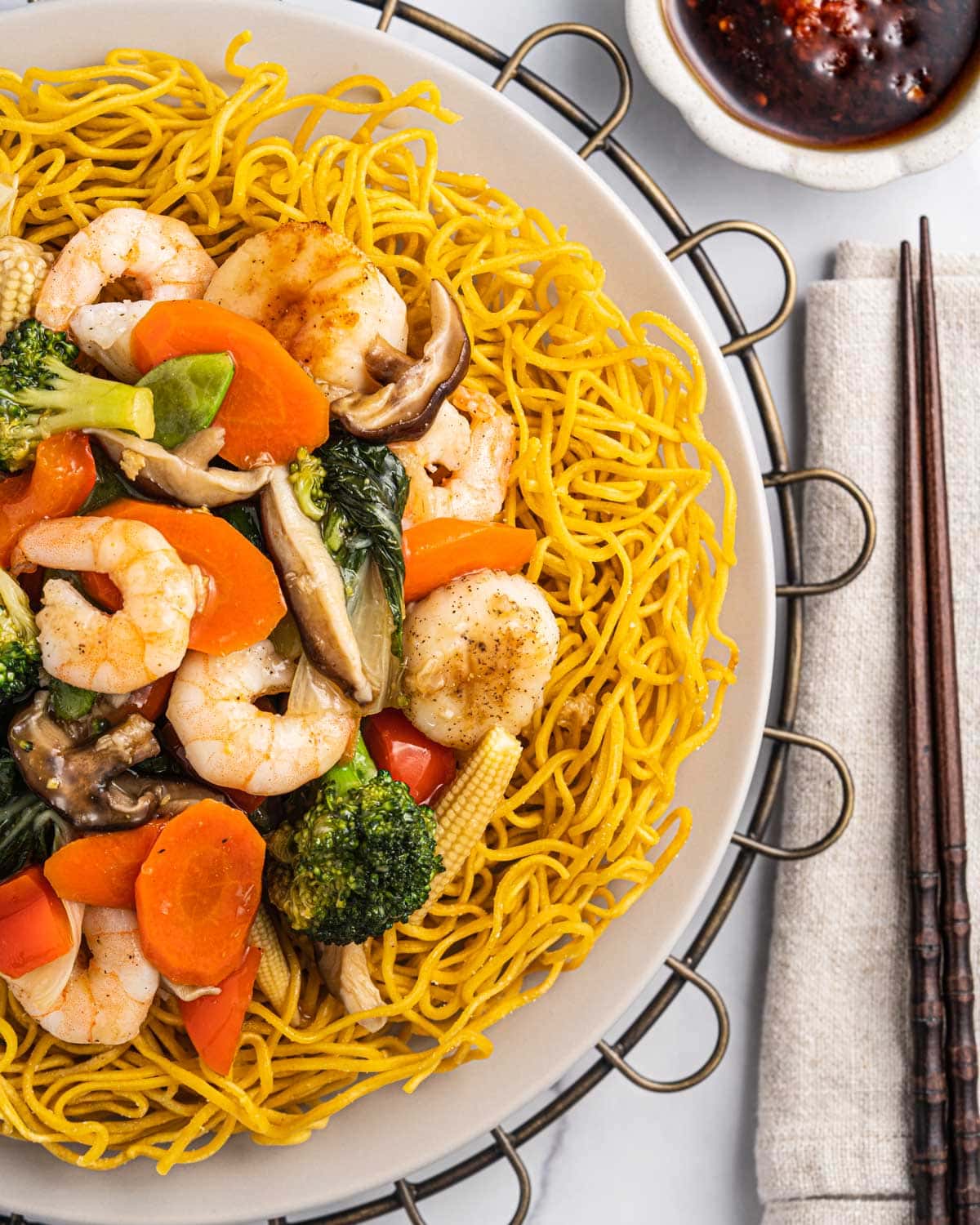 Mi Xao Don, crispy pan fried noodles, topped with seafood, vegetables, and sauce.