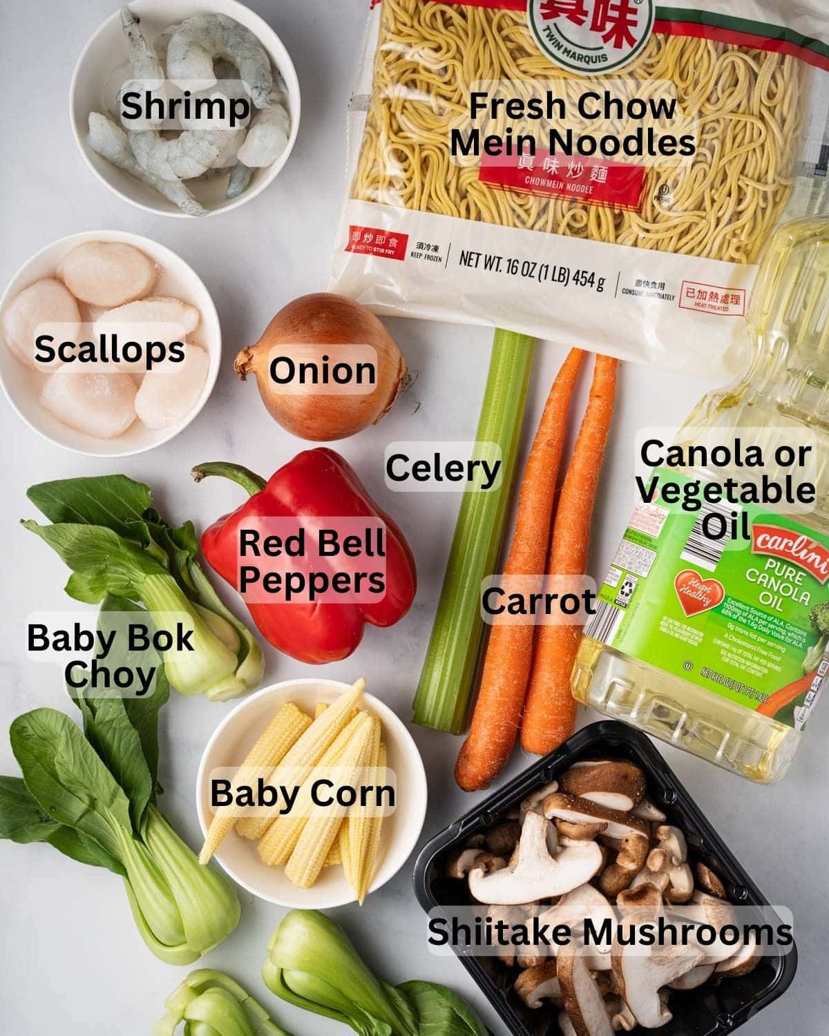 Ingredients needed for mi xao gion: fresh chow mein noodles, shrimp, scallops, onion, celery, carrots, red bell peppers, baby bok choy, baby corn, shiitake mushrooms, and oil.