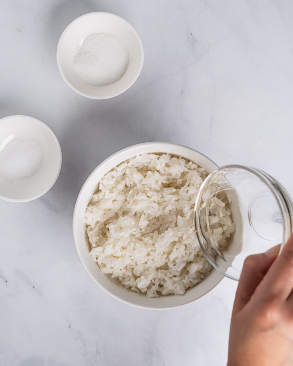 Combining rice vinegar, sugar and salt into the sushi rice.