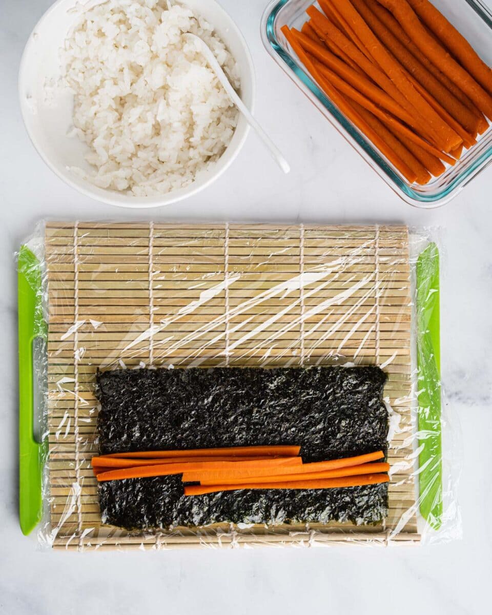 Placing yamagobo matchsticks on the seaweed.