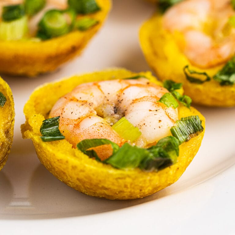 Close up of banh khot with shrimp and scallion oil on top