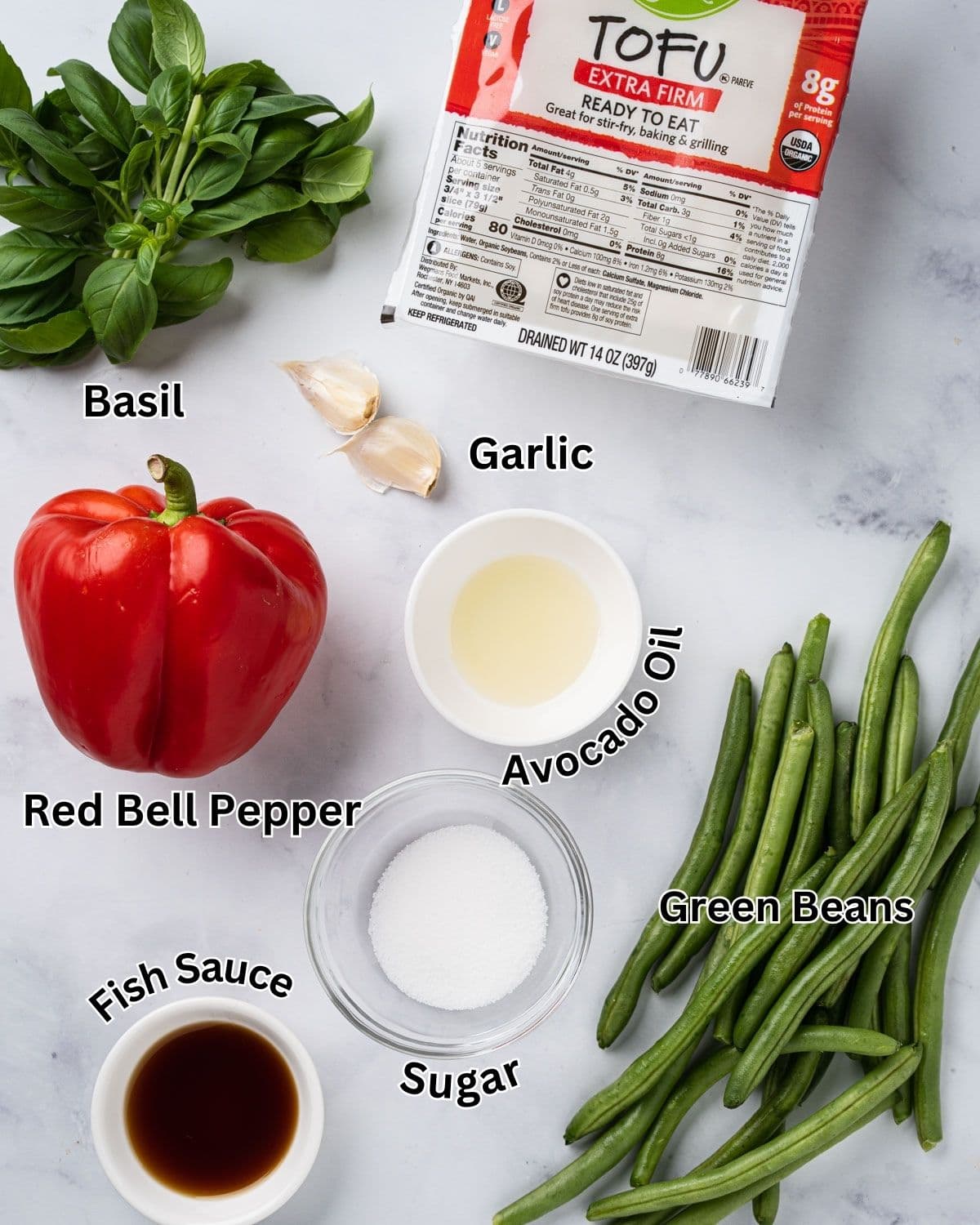 Ingredients needed for tofu pad krapow: extra firm tofu, basil, garlic, red bell peppers, green beans, avocado oil, fish sauce, soy sauce, and sugar.