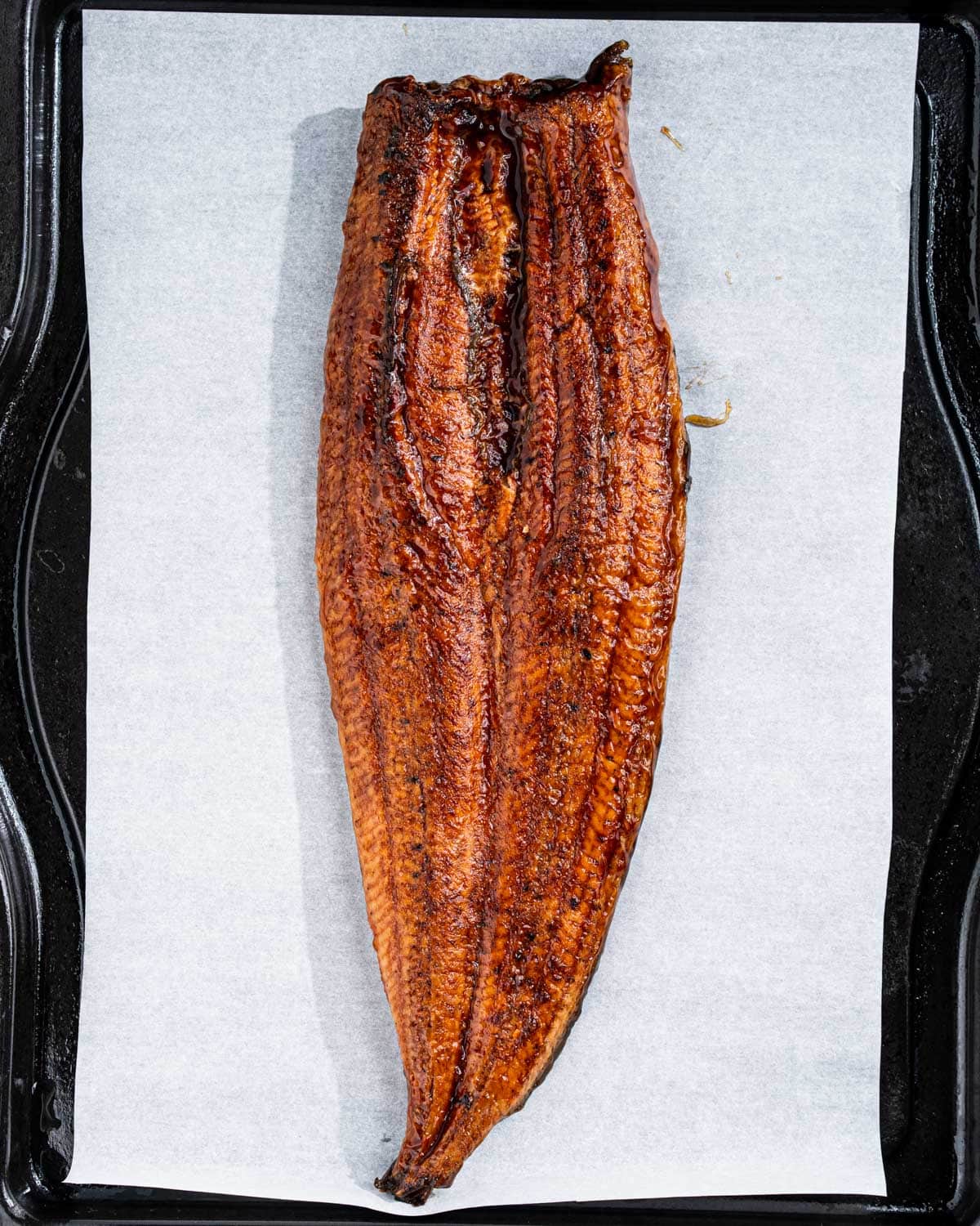 Thawed eel on baking tray before reheating.