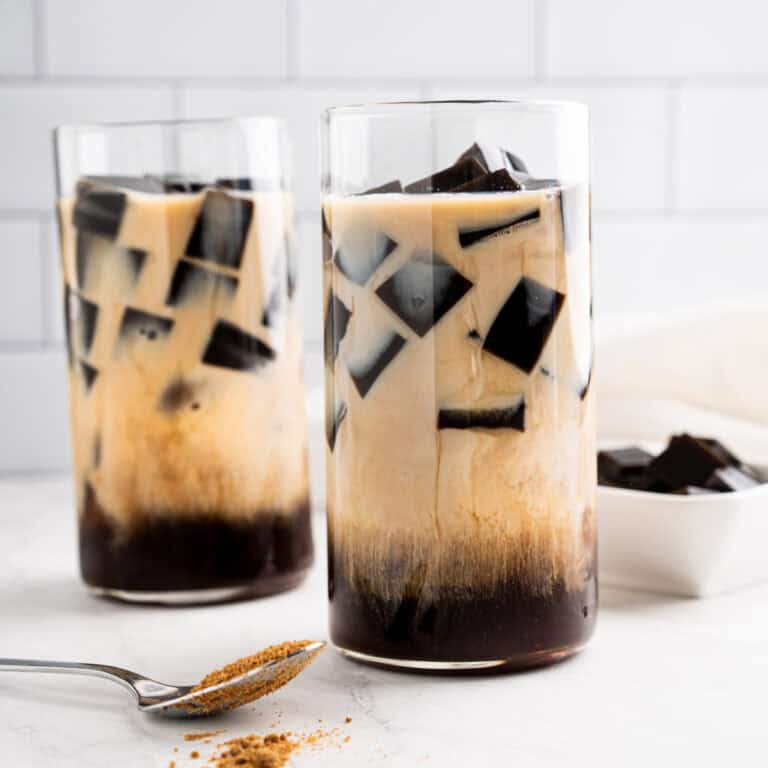 2 Glass cups of grass jelly drink with brown sugar milk tea.