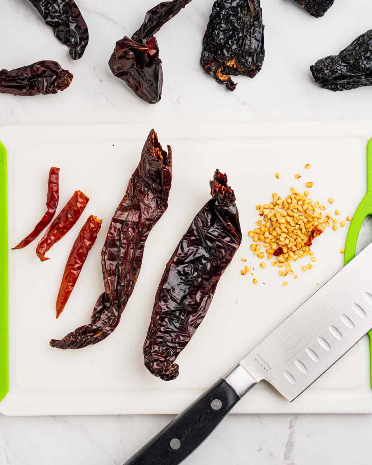 Removing seeds from dried peppers.