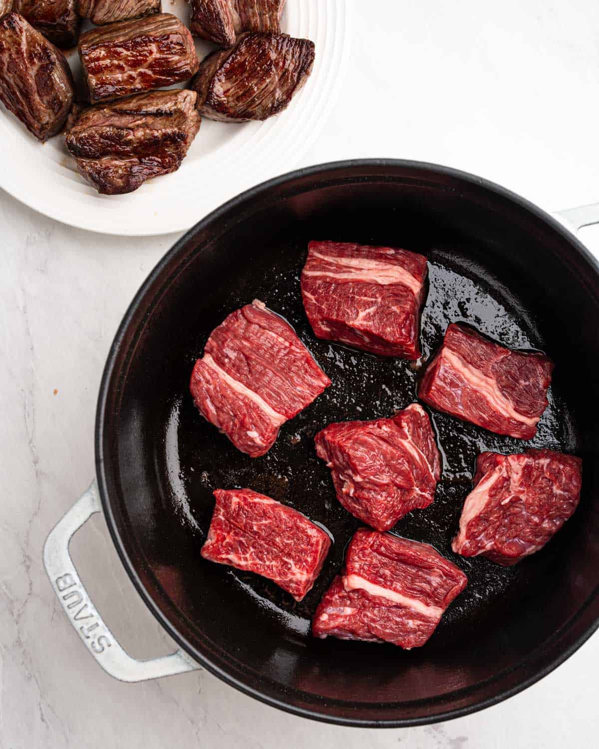 Pan searing beef on all sides in pot.
