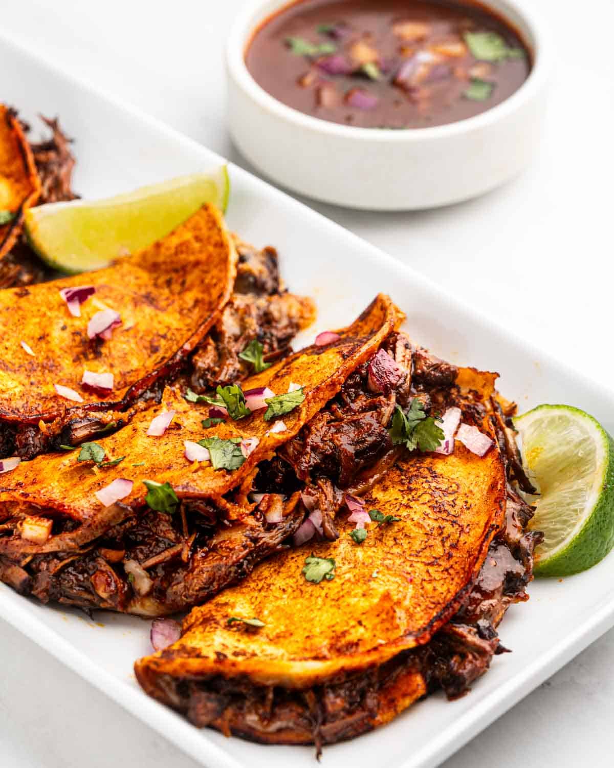 close up for birria taco and shredded meat.
