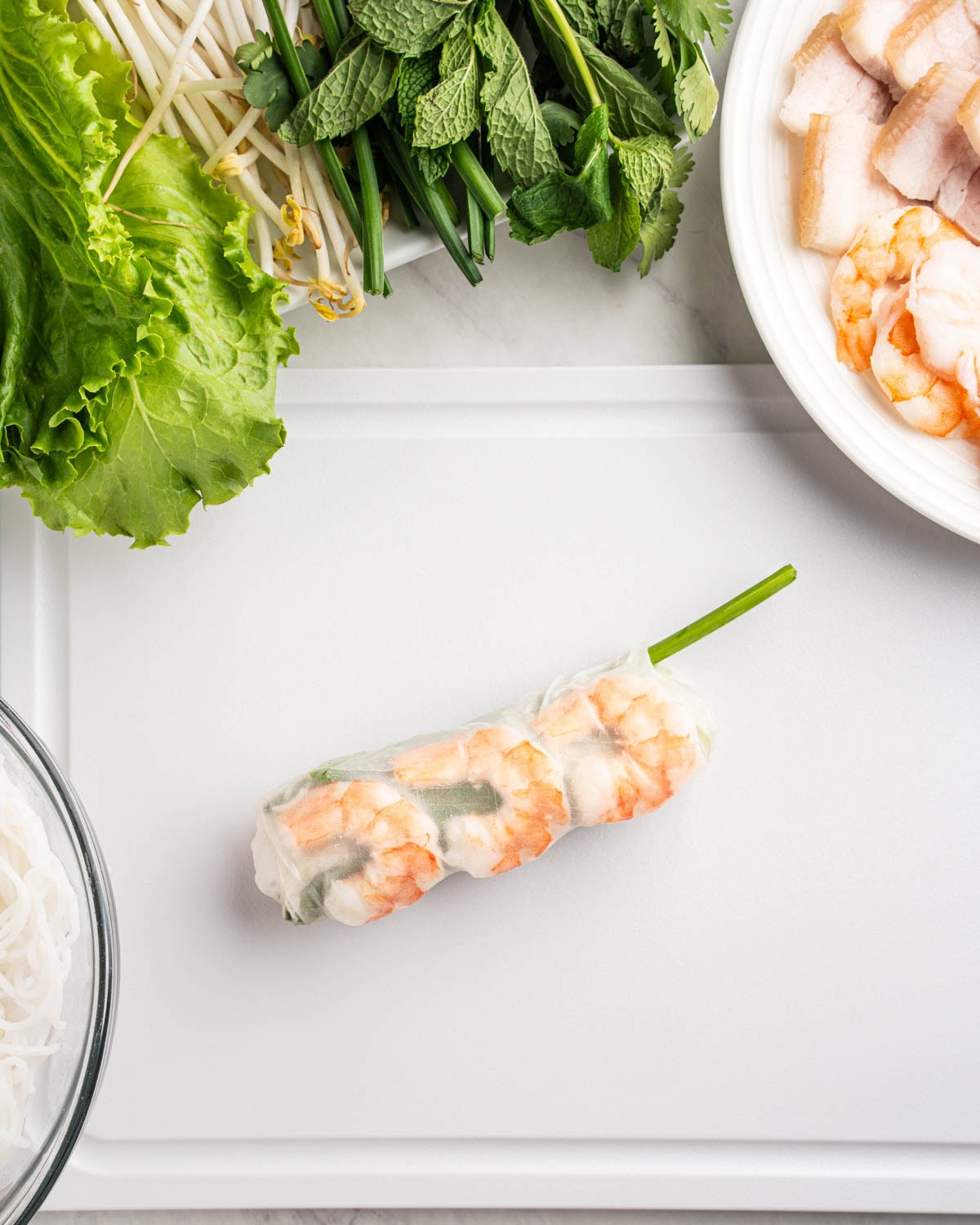 wrapped spring roll on a cutting board.