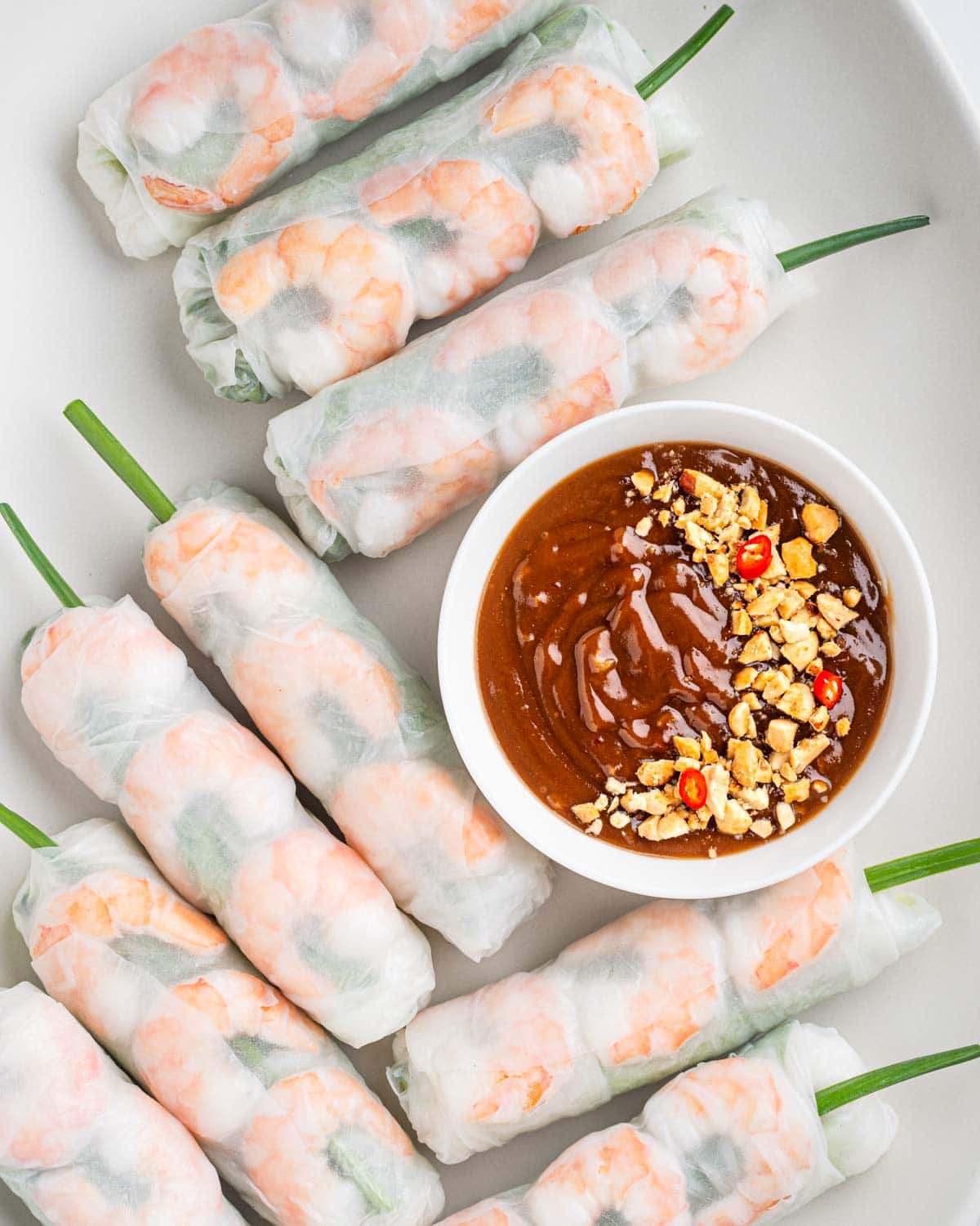 summer rolls goi cuon with peanut sauce on a plate.