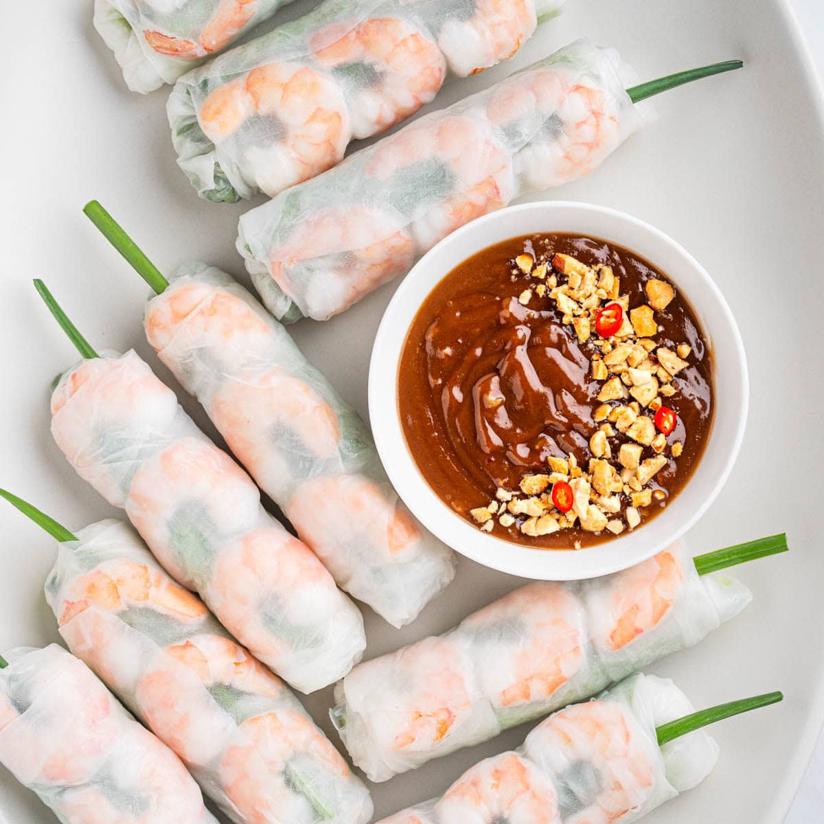 spring rolls goi cuon with peanut sauce on a plate.