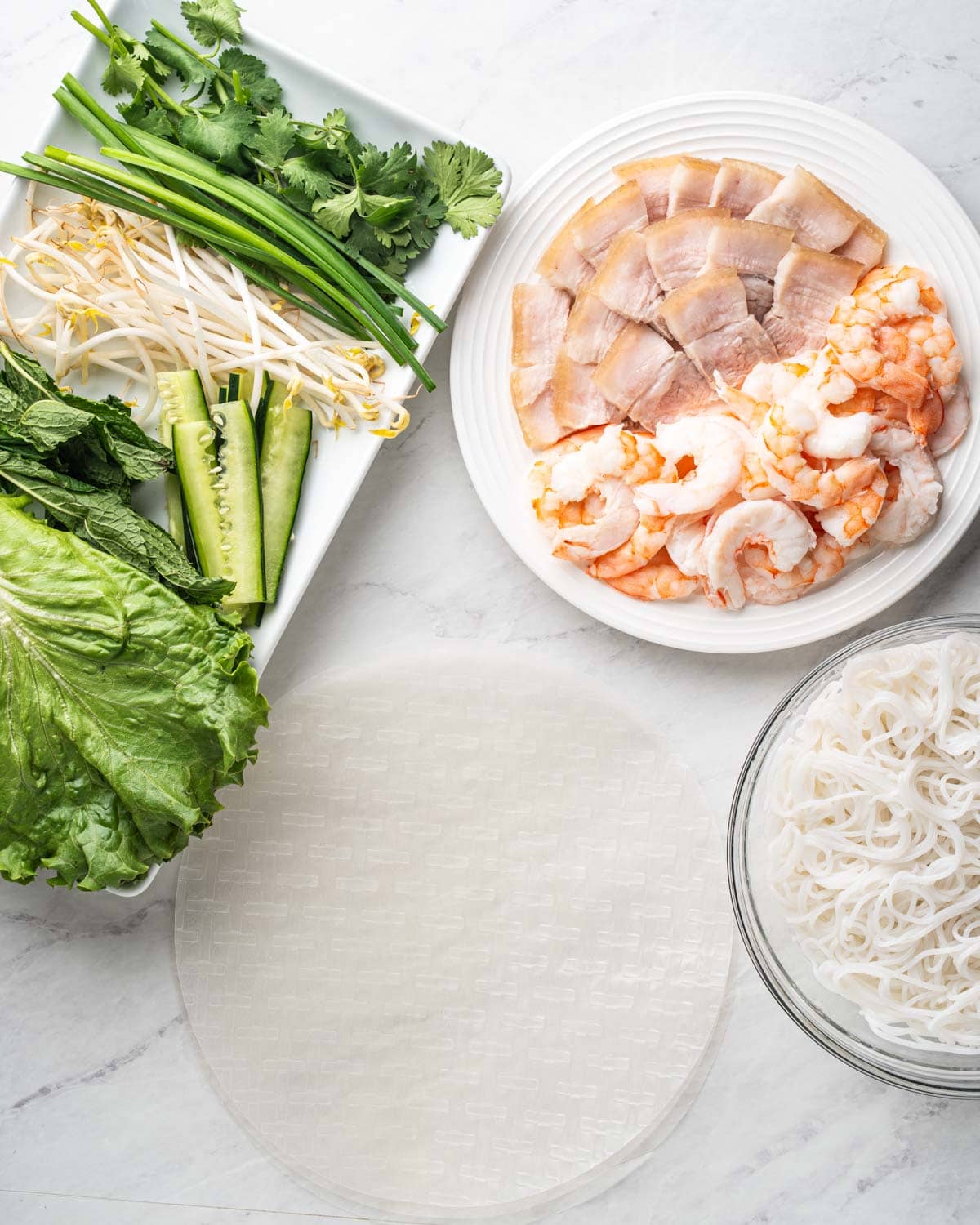 cooked ingredients ready to assemble goi cuon spring rolls.