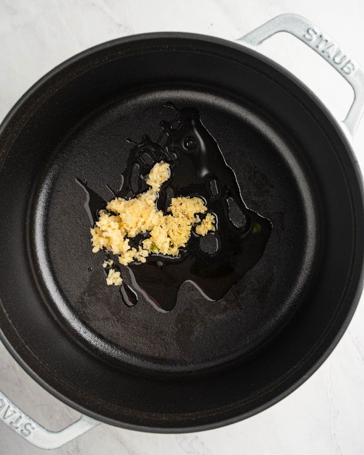 Sautéing garlic and ginger in pot.