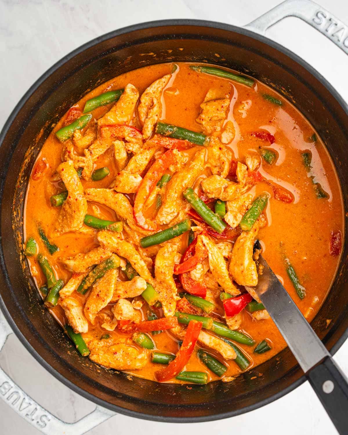 coconut chicken curry with vegetables in a pot.