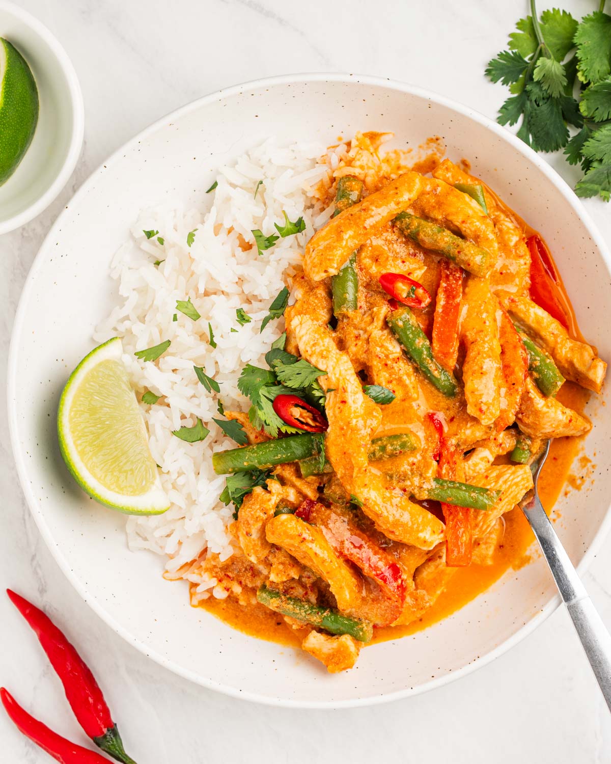 Plate of coconut chicken Thai red curry over rice.