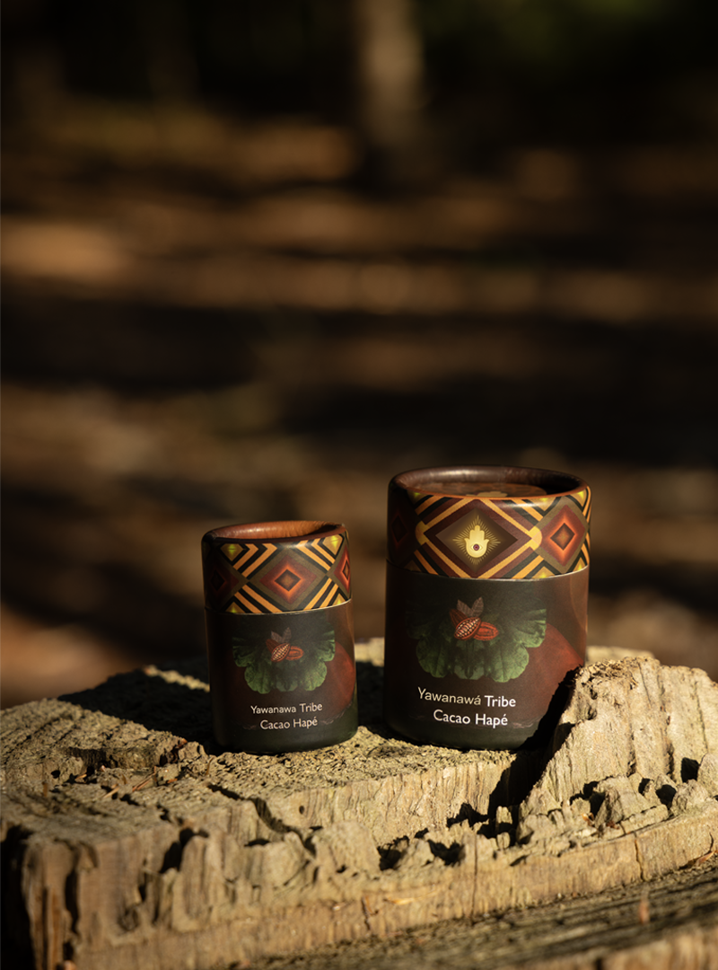 Handcrafted indigenous cacao containers with tribal designs, representing Yawanawa Tribe, in an outdoor natural setting for traditional healing and spiritual connection.