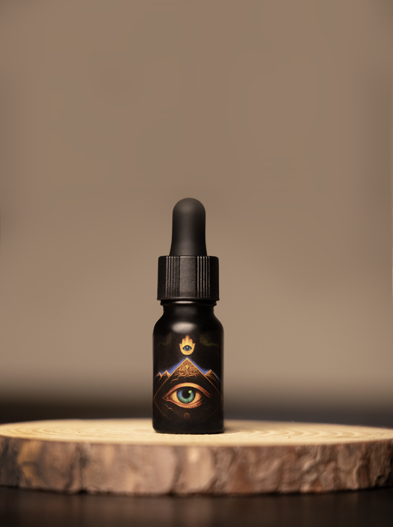 Liquid oracle oil dropper bottle with mystical eye and mountain artwork, used for spiritual healing, sacred practices, and energy work in shamanic rituals. Perfect for holistic wellness and intuitive guidance.