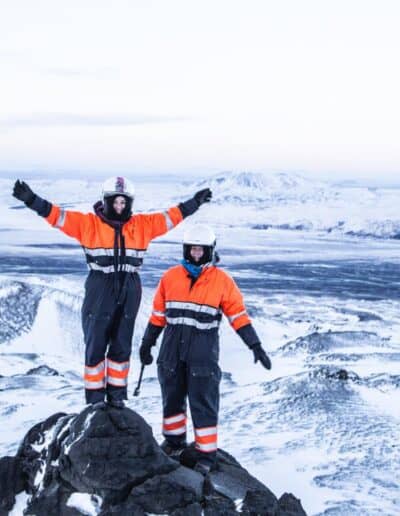 Two persons in orange and black winter