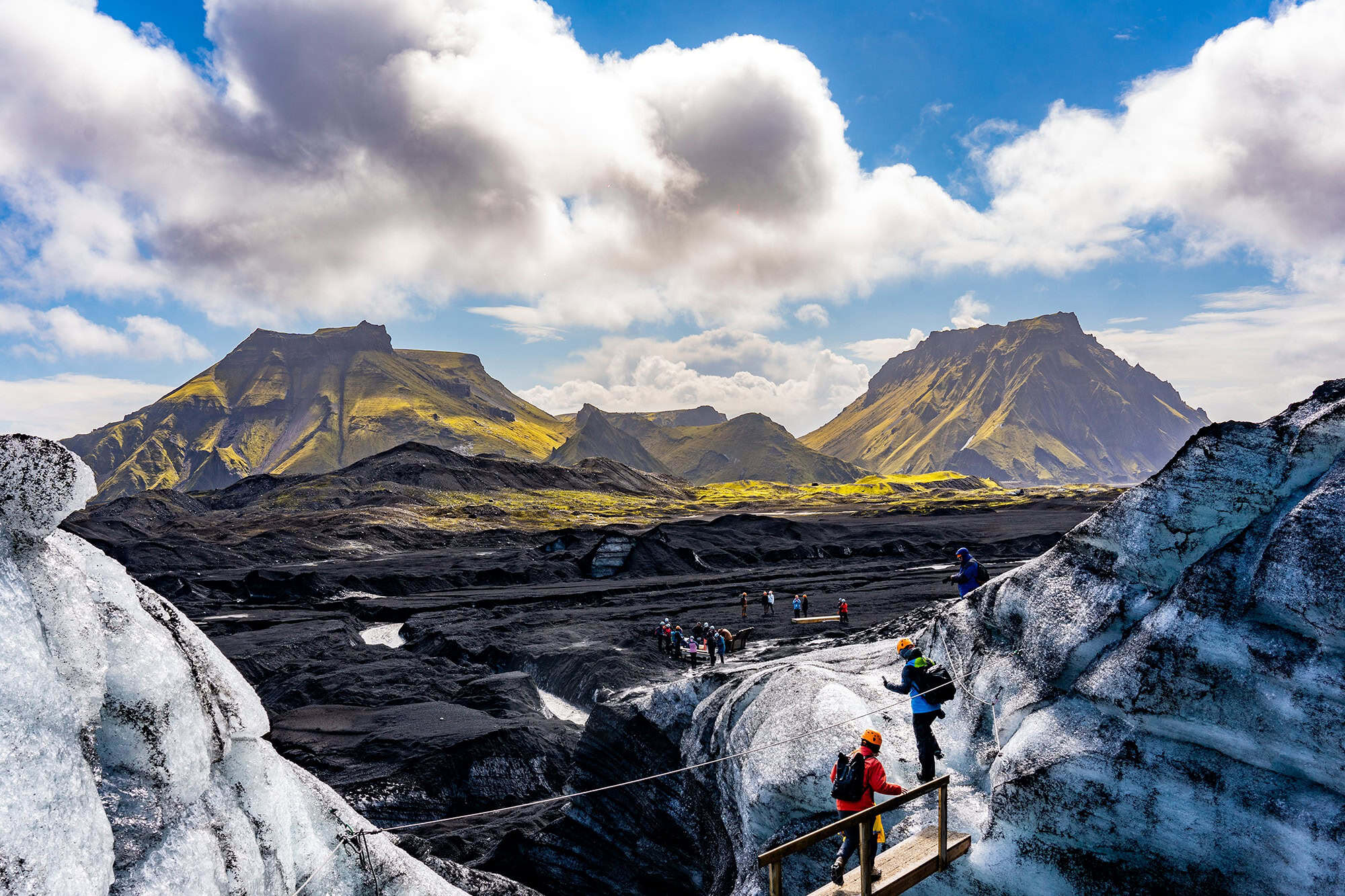 A view from Katla Ice Cave showing mountains and glacier and cloudy sky in daylight