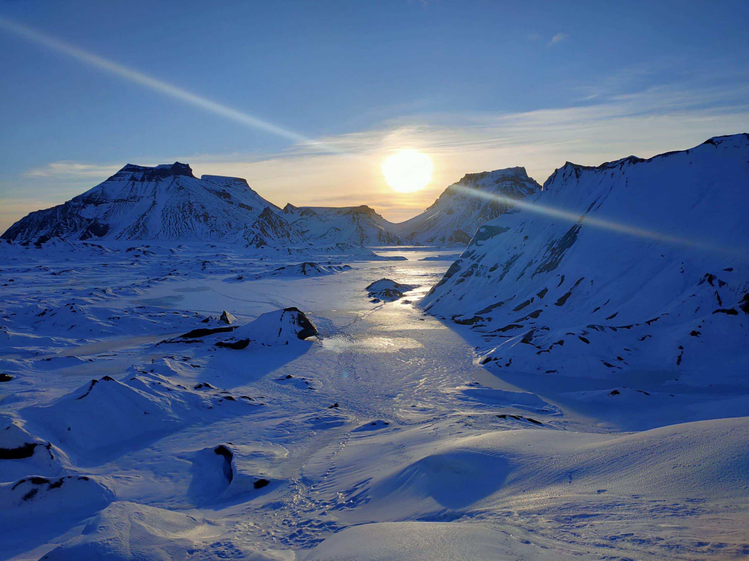 A sunset with snowy mountains and glacier from Katla.