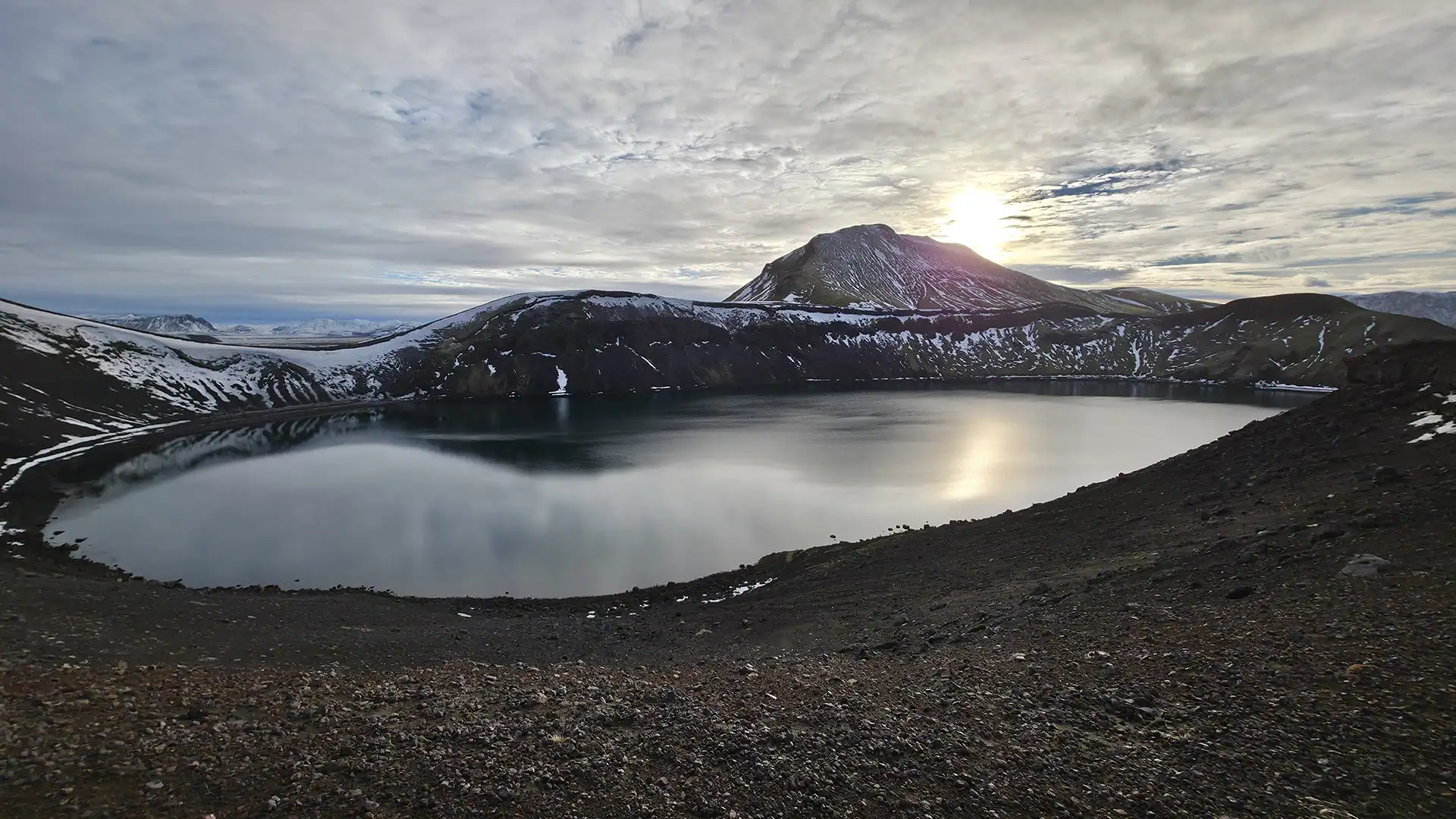 A still water surrounded by mountains on a super jeep tour