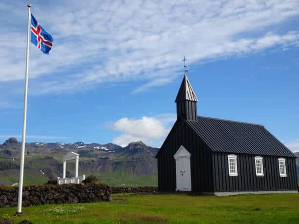 With a national flag and a clear blue sky.