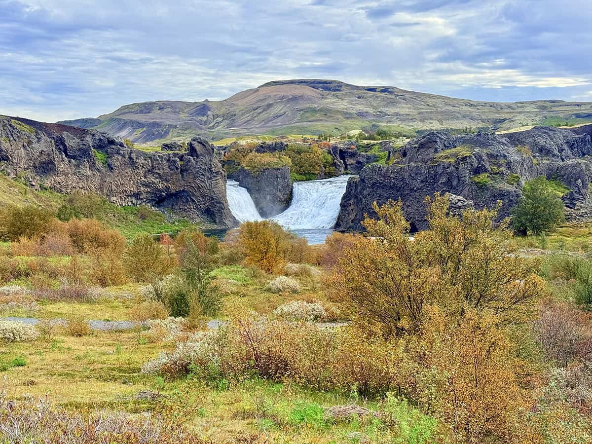 Hjálparfoss Waterfall in Þjórsárdalur Valley, South Iceland, Surrounded by Basalt Cliffs and Volcanic Landscape